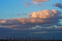 The skyline of downtown Dubai on a rare cloudy day is seen at sunset in Dubai, United Arab Emirates, Saturday, Dec. 4, 2021.