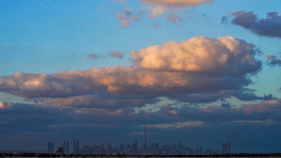 The skyline of downtown Dubai on a rare cloudy day is seen at sunset in Dubai, United Arab Emirates, Saturday, Dec. 4, 2021.