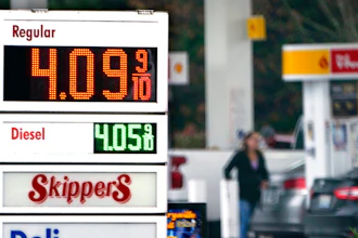 A driver fills a tank at a gas station on Dec. 10, 2021 in Marysville, WA.