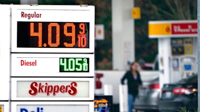 A driver fills a tank at a gas station on Dec. 10, 2021 in Marysville, WA.