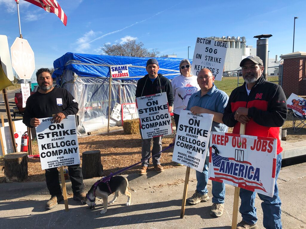 Striking Kellogg's workers Michael Rodarte, Sue Griffin, Michael Elliott, Eric Bates and Mark Gonzalez stand outside the Omaha, NE cereal plant on Dec. 2, 2021.