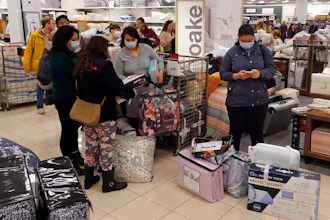 Customers wait in line to checkout during a Black Friday sale at Macy's on Nov. 26, 2021, in Indianapolis.