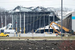 Crews move in heavy equipment for search and rescue operations at the Amazon distribution center in Edwardsville, Ill., on Saturday, Dec. 11, 2021. Overnight severe storms caused the building to partially collapse with confirmed fatalities according to police. The roof of the building was ripped off and a wall about the length of a football field collapsed.