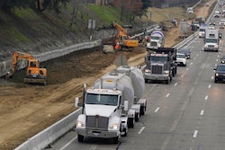 Trucks and other vehicles pass a construction zone on Highway 50 in Sacramento, Calif., Monday, Dec. 6, 2021. The California Air Resources Board, on Thursday, Dec. 9, 2021, is considering a new smog check program for heavy duty trucks. The new rules would require trucks weighing more than 14,000 pounds to be tested at least twice per year to make sure they meet the state's smog standards.