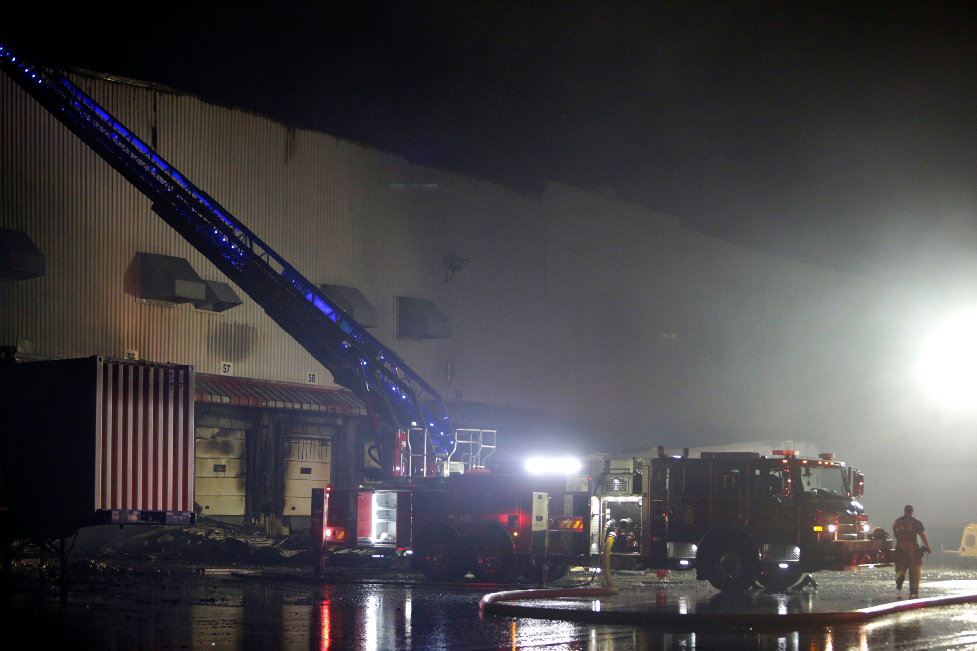 Firefighters work on cleanup after a fire ripped through a distribution center for the QVC home-shopping television network in Rocky Mount, N.C. on Saturday, Dec. 18, 2021. More than 300 employees were working at the facility when the fire was reported shortly after 2a.m. No injuries were immediately reported.