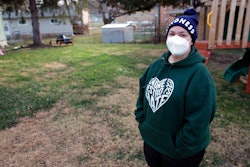 Sonja Redding, an unemployed mother of two, stands outside her home in Omaha, Nebraska on Monday, Dec. 6, 2021. Redding has been trying to find a job, but it's difficult because she feels she needs to stay at home to care for her children who have special needs and are particularly vulnerable to viruses.