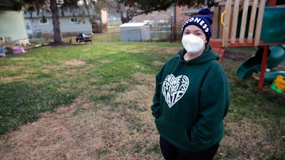 Sonja Redding, an unemployed mother of two, stands outside her home in Omaha, Nebraska on Monday, Dec. 6, 2021. Redding has been trying to find a job, but it's difficult because she feels she needs to stay at home to care for her children who have special needs and are particularly vulnerable to viruses.