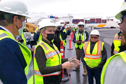 U.S. Energy Secretary Jennifer Granholm, center, speaks with workers, and Rhode Island Gov. Dan McKee, left, Thursday Dec. 2, 2021, while visiting an under construction fabrication and assembly facility for offshore wind turbines at the Port of Providence, in Providence, R.I. The building is scheduled to be finished this spring to support two offshore wind projects, Revolution Wind and South Fork Wind.