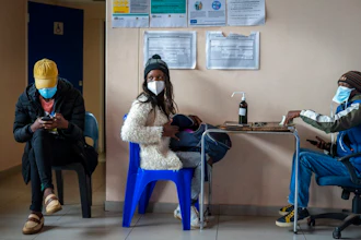 Takalane Mulaudzi, 29, is processed before getting her COVID-19 vaccination at Soweto's Baragwanath hospital Monday Dec.13, 2021. Despite having adequate supplies of more than 19 million vaccine doses, South Africa's vaccination campaign has lagged. Around 38 percent of the adult population in South Africa has been vaccinated. The relatively slow rate of vaccinations makes the government's goal of inoculating 67% of the population by February 2022 look unrealistic.