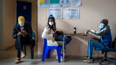 Takalane Mulaudzi, 29, is processed before getting her COVID-19 vaccination at Soweto's Baragwanath hospital Monday Dec.13, 2021. Despite having adequate supplies of more than 19 million vaccine doses, South Africa's vaccination campaign has lagged. Around 38 percent of the adult population in South Africa has been vaccinated. The relatively slow rate of vaccinations makes the government's goal of inoculating 67% of the population by February 2022 look unrealistic.