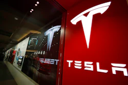 This photo shows a sign bearing the company logo outside a Tesla store Feb. 9, 2019 in Cherry Creek Mall in Denver. Tesla says it has officially moved its corporate headquarters from Silicon Valley to a large factory under construction outside of Austin, Texas. The company made the announcement late Wednesday, Dec. 1, 2021 in a filing with U.S. securities regulators.