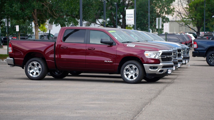 Only a handful of unsold 2021 Ram pickup trucks sit on the empty storage lot outside a Ram dealership on Sunday, Aug. 29, 2021, in Littleton, Colo.