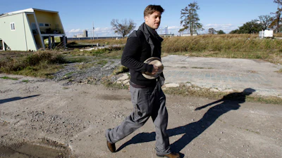 Brad Pitt walks past one of the first homes built in New Orleans by his Make It Right Foundation in this 2008 photo.