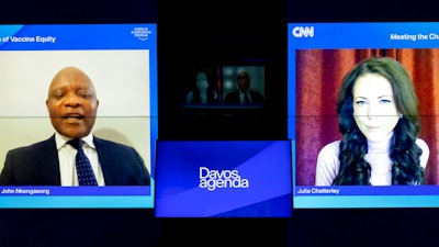 Screens show John Nkengasong, left, Director of the Africa Centres for Disease Control and Prevention (Africa CDC), and Moderator Julia Chatterley, right, during a remote panel titled 'The Challenge of Vaccine Equity', at the Davos Agenda 2022, in Cologny near Geneva, Switzerland, on Jan. 18, 2022.
