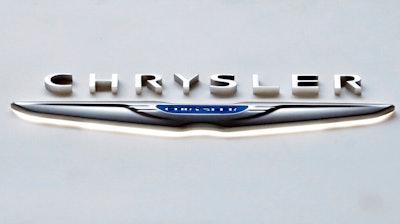 The Chrysler logo at the 2019 Pittsburgh International Auto Show is displayed on Feb. 14, 2019. Chrysler says, Wednesday, Jan. 5, 2022, it plans for its vehicle lineup to go all electric by 2028. It's the latest brand to announce a major shift away from gas-powered cars amid pressure to act on climate change.