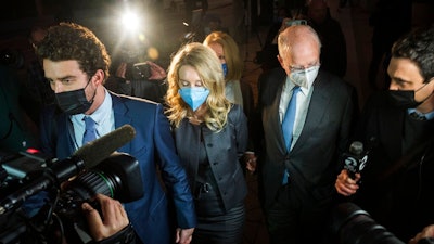 Elizabeth Holmes leaves federal court after the verdict in San Jose, Calif., Monday, Jan. 3, 2022. Holmes was convicted of fraud for turning her blood-testing startup Theranos into a sophisticated sham that duped billionaires and other unwitting investors into backing a seemingly revolutionary company whose medical technology never worked as promised.