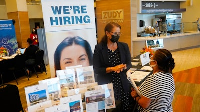 Marriott human resources recruiter Mariela Cuevas, left, talks to Lisbet Oliveros, during a job fair at Hard Rock Stadium, Friday, Sept. 3, 2021, in Miami Gardens, Fla. Federal Reserve policymakers at a meeting last month said the U.S. job market was nearly at levels healthy enough that the central bank's low-interest rate policies were no longer needed. That's according to minutes of the meeting released Wednesday, Jan. 5, 2022.