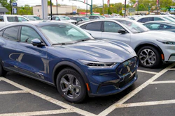 A pair of 2021 Ford Mustang Mach E are displayed for sale at a Ford dealer on Thursday, May 6, 2021, in Wexford, Pa. U.S. new vehicle sales rebounded slightly last year from 2020′s dismal numbers, but forecasters expect them to be more than 2 million below the years before the coronavirus pandemic.