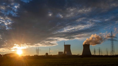 Steam rises from the cooling tower of the nuclear power plant of Gundremmingen, Bavaria, Germany, Friday, Dec. 31, 2021. Draft European Union plans that would allow nuclear and gas energy to remain part of the bloc's path to a climate-friendly future came under immediate criticism over the weekend from both environmentalists and some governing political parties in EU member nations. Germany shut three plants, including this one, at the end of last year.