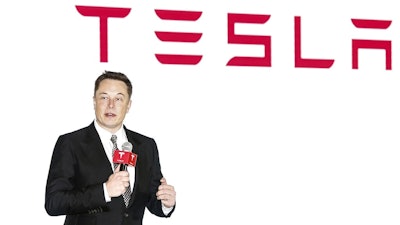 Tesla CEO Elon Musk holds a press conference to introduce the auto-driving system upgrade for Chinese Tesla owners in Beijing, China on Oct. 23, 2015. Activists on Monday, Jan 3. 2022 are appealing to Elon Musk and Tesla Inc. to close a new showroom in China's northwestern region of Xinjiang, where officials are accused of abuses against mostly Muslim ethnic minorities.