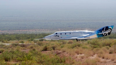 In this July 11, 2021, file photo the Virgin Galactic rocket plane, with founder Richard Branson and other crew members on board, lands back in Spaceport America near Truth or Consequences, N.M. New Mexico lawmakers are considering taxing tickets purchased by Virgin Galactic passengers. A bipartisan bill introduced in the state Legislature seeks to close a loophole that excluded spaceflight passenger tickets from gross receipts taxes.