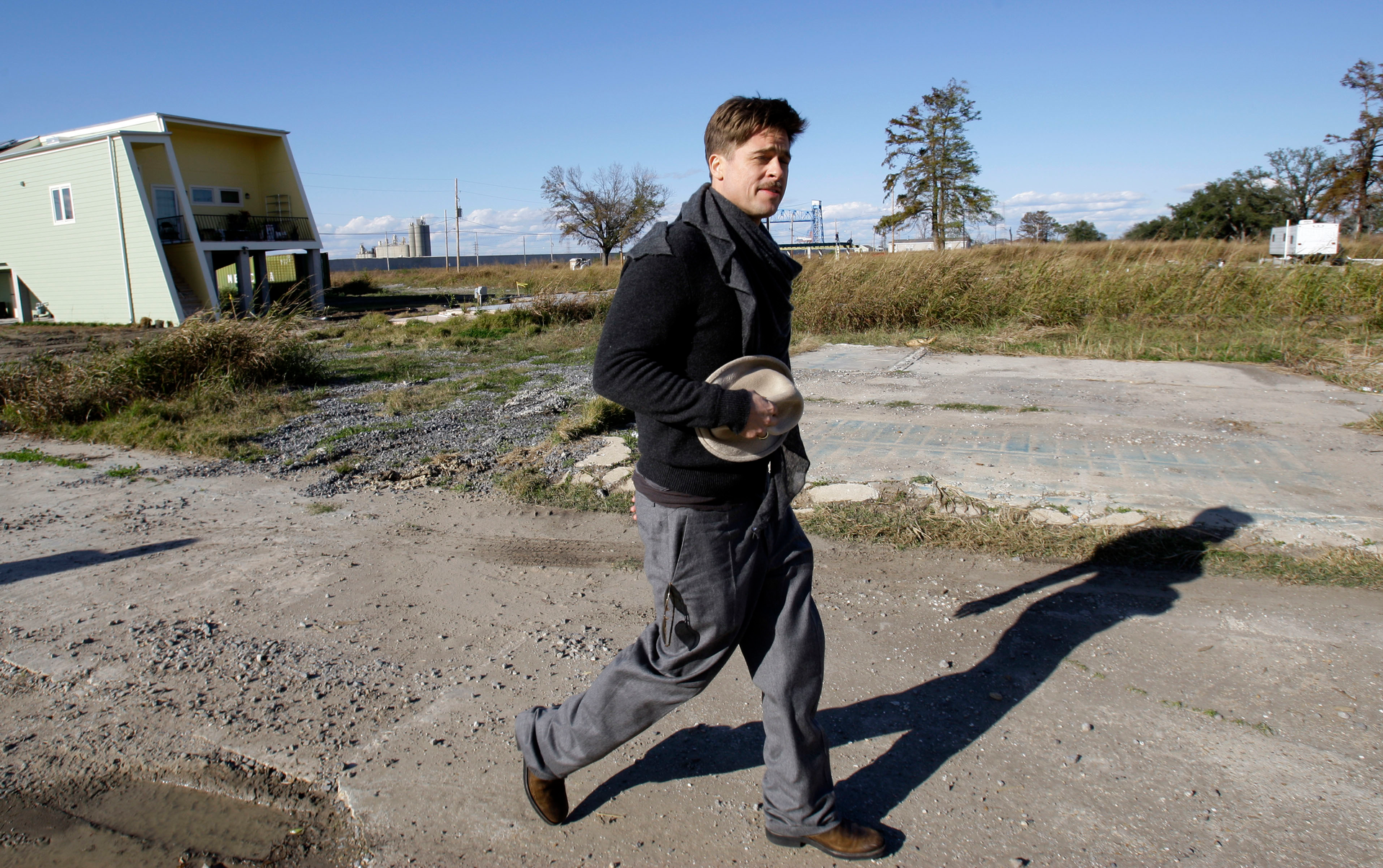 Brad Pitt walks past one of the first homes built in New Orleans by his Make It Right Foundation in this 2008 photo.