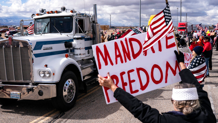 Supporters cheer on the beginning of a trucker caravan to Washington, D.C., called The People's Convoy on Feb. 23, 2022, in Adelanto, Calif. A small convoy of truckers demanding an end to coronavirus mandates began a cross-country drive from California to the Washington, D.C., area on Wednesday.