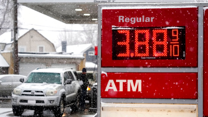 Motorists fill up vehicles at a gas station Wednesday, Feb. 16, 2022, in Denver. U.S. consumer confidence declined modestly this month but remains high, even as prices for just about everything continue to rise.