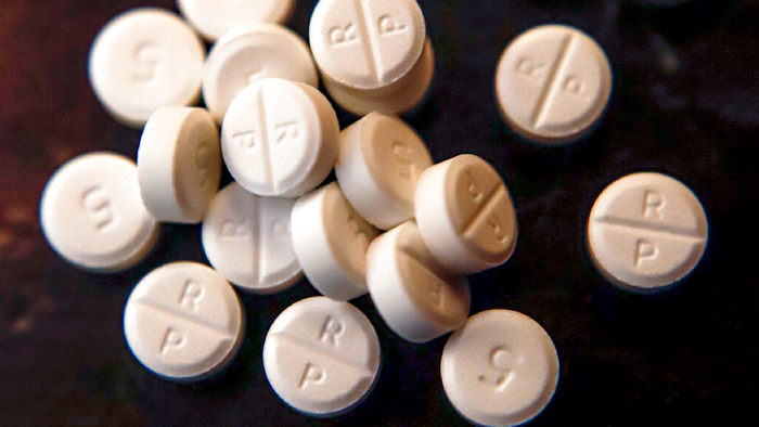 This June 17, 2019, file photo shows 5-mg pills of Oxycodone. Native American tribes in the U.S. have reached settlements worth $590 million over opioids. A court filing made Tuesday, Feb. 1, 2022 in Cleveland lays out the details of the settlements with drugmaker Johnson & Johnson and distribution companies AmerisoruceBergen, Cardinal Health and McKesson.