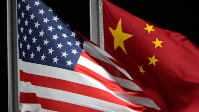 American and Chinese flags wave at Genting Snow Park, Zhangjiakou, China, Feb. 2, 2022.