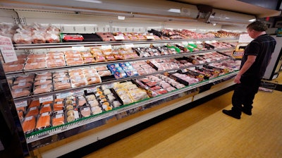A man looks at beef in the meat department at Lambert's Rainbow Market on June 15, 2021 in Westwood, Mass.
