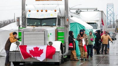 Truckers and supporters block the access leading from the Ambassador Bridge, linking Detroit and Windsor, as truckers and their supporters continue to protest against COVID-19 vaccine mandates and restrictions, in Windsor, Ontario on Feb. 11, 2022.