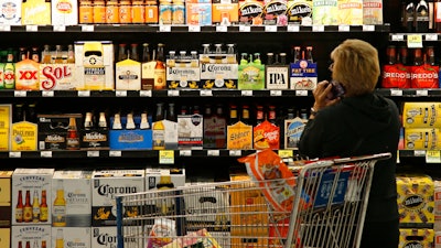 In this Oct. 1, 2018 photo, a customer looks over the beer selection at Crest Foods in Oklahoma City.