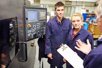 Engineer Teaching Apprentices To Use Computerized Lathe 458860281 2122x1415 (1)