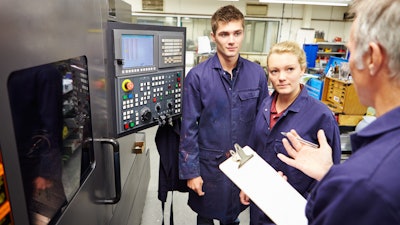 Engineer Teaching Apprentices To Use Computerized Lathe 458860281 2122x1415 (1)