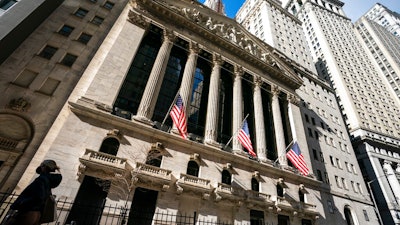 A pedestrian walks past the New York Stock Exchange, Jan. 24, 2022, in New York. Markets are trembling again as fighting intensifies in Ukraine and as Western nations ratchet up steps to further isolate and punish Russia economically for its aggression. The S&P 500 fell 1% in early trading Monday, Feb, 28, 2022 oil prices surged and investors shifted money into safe havens like U.S. government bonds.