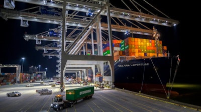 Five ship to shore cranes and gangs of longshoremen work to load and unload the container ship CMA CGM Laperouse at the Georgia Ports Authority's Port of Savannah, Sept. 29, 2021, in Savannah, Ga. The Port of Savannah has added another month to its streak of record cargo volumes amid a surge that’s forced U.S. seaports to scramble to meet demand. The Georgia Ports Authority reported nearly 480,000 container units of imports and exports moved across Savannah’s docks last month. That’s an increase of 4% compared with January 2021, when cargo volumes were already unusually high.