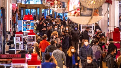 People shop in Macy's on Nov. 26, 2021, in New York. Americans picked up the spending pace in January as the threat of omicron faded and there was some easing of supply shortages. Retail sales rose a seasonally adjusted 3.8% Jan. 2022, compared to the prior month when the number dropped a revised 2.5%.