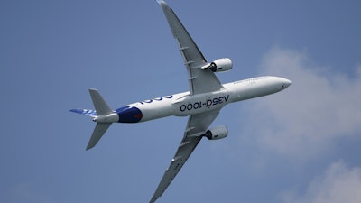 An Airbus A350-1000 aircraft participates in a fly-by during the Singapore Airshow 2022 at Changi Exhibition Centre in Singapore, Tuesday, Feb. 15, 2022.