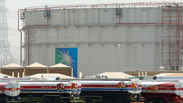 Fuel trucks line up in front of storage tanks at the North Jiddah bulk plant, an Aramco oil facility, in Jiddah, Saudi Arabia, on March 21, 2021.