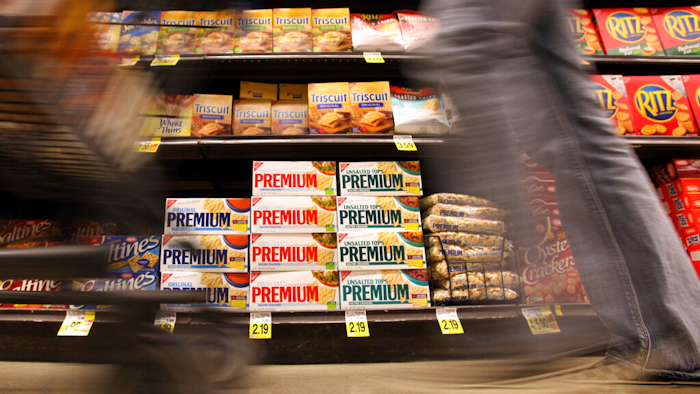 In this Feb. 9, 2011 photo, a shopper passes Nabisco products, a Mondelez International brand: Premium saltines, Triscuits, Ritz crackers and Wheat Thins, at a supermarket in Los Angeles. Ukrainian President Volodymyr Zelenskyy is stepping up the country's pleas to pressure companies to exit Russia.