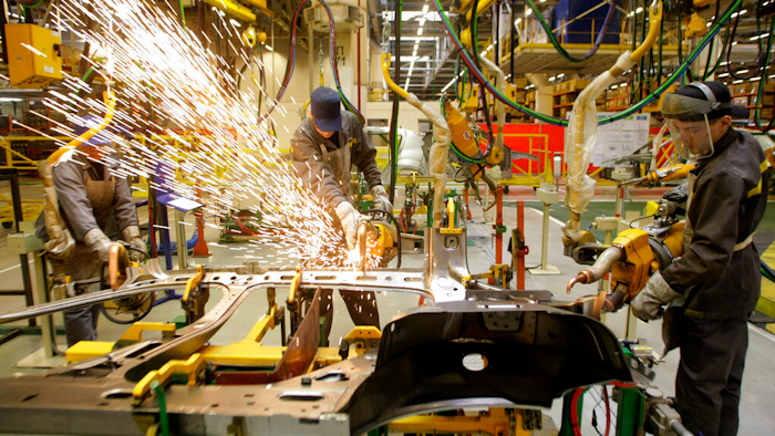 Workers of Renault's Moscow plant prepare car parts for the production line, on March 1, 2010. French automaker Renault moved to pause production at its Moscow plant in an apparent move to fend off mounting criticism, breaking ranks with other major French companies that have defied pressure to keep operating in Russia.