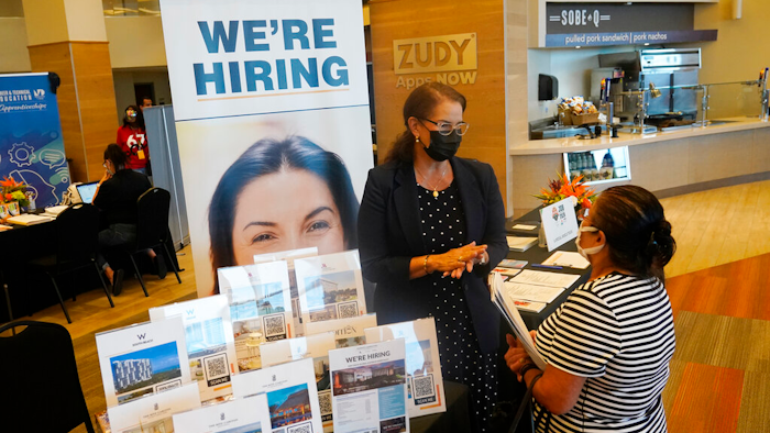 Marriott human resources recruiter Mariela Cuevas, left, talks to Lisbet Oliveros, during a job fair at Hard Rock Stadium, Friday, Sept. 3, 2021, in Miami Gardens, Fla. Fewer Americans applied for unemployment benefits last week, as layoffs continue to decline amid a strong job market rebound. Jobless claims fell by 15,000 to 214,000 for the week ending March 12, 2022 down from the previous week's 229,000, the Labor Department reported Thursday, March 17.