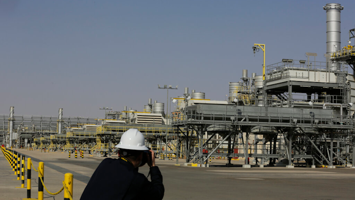 A photographer takes pictures of the Khurais oil field during a tour for journalists, 150 km east-northeast of Riyadh, Saudi Arabia, June 28, 2021. In a statement on Monday, March 21, 2022, carried by the state-run Saudi Press Agency, Saudi Arabia said it “won’t bear any responsibility for any shortage in oil supplies to global markets” after attacks by Yemen’s Iran-backed Houthi rebels have affected the kingdom’s production.