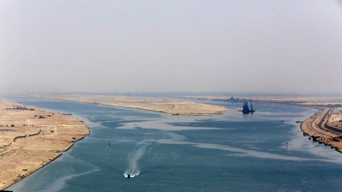 An army zodiac secures the entrance of a new section of the Suez Canal in Ismailia, Egypt, Aug. 6, 2015. Cash-strapped Egypt increased transit fees Tuesday, March 1, 2022, for ships passing through the Suez Canal, one of the world’s most crucial waterways, with hikes of up to 10%, officials said.