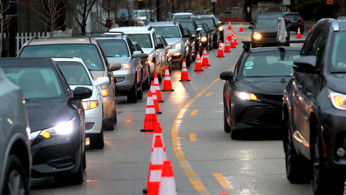 Cars line up early morning along Green Bay Road waiting to receive free gas donated by Willie Wilson at the Mobil Gas Station on Thursday, March 24, 2022, in Evanston, Ill.