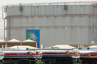 Fuel trucks line up in front of storage tanks at the North Jiddah bulk plant, an Aramco oil facility, in Jiddah, Saudi Arabia, on March 21, 2021.