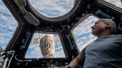 U.S. astronaut and Expedition 66 Flight Engineer Mark Vande Hei peers at the Earth from the International Space Station, Feb. 4, 2022.