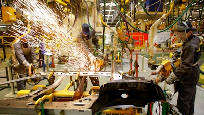 Workers of Renault's Moscow plant prepare car parts for the production line, on March 1, 2010. French automaker Renault moved to pause production at its Moscow plant in an apparent move to fend off mounting criticism, breaking ranks with other major French companies that have defied pressure to keep operating in Russia.