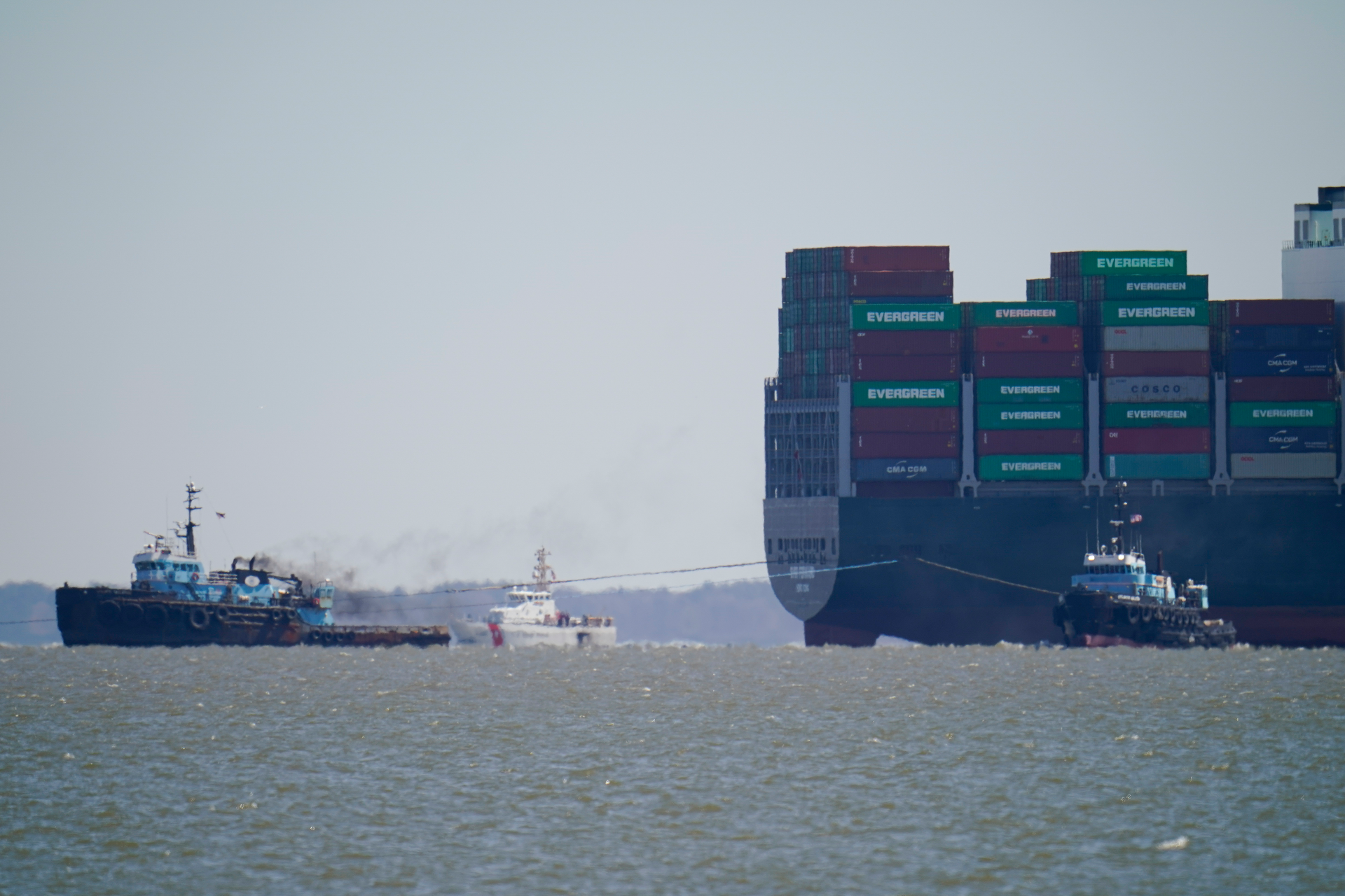 The tugboats Atlantic Enterprise, left, and Atlantic Salvor, bottom right, use lines to pull the container ship Ever Forward, top right, which ran aground in the Chesapeake Bay, Pasadena, Md., March 29, 2022.